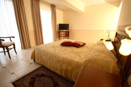 a bedroom with a bed with two pillows on it at Park Hotel Tyrrenian in Amantea