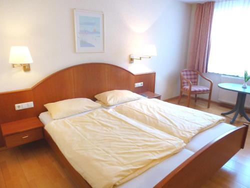1 dormitorio con 1 cama grande y cabecero de madera en Apartment Flesch-2 by Interhome, en Schelingen