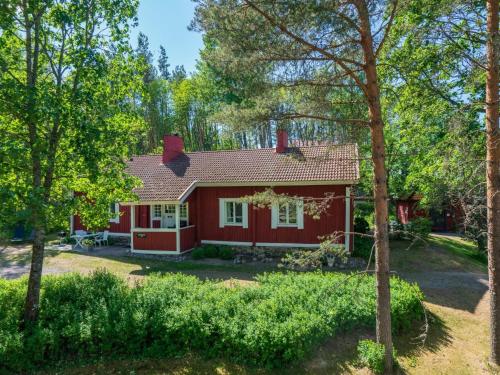 una cabaña roja en el bosque con árboles en Holiday Home Pikkupehtoori by Interhome, en Hirsjärvi