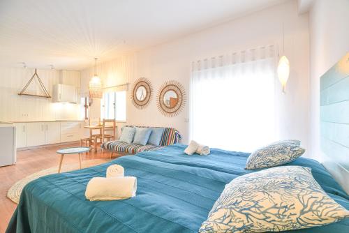 a bedroom with two beds and a kitchen at Salema Eco Camp - Sustainable Camping & Glamping in Salema