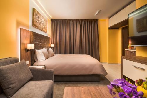 a hotel room with a bed and a couch at АРТ СТУДИО СОФИЯ in Sofia