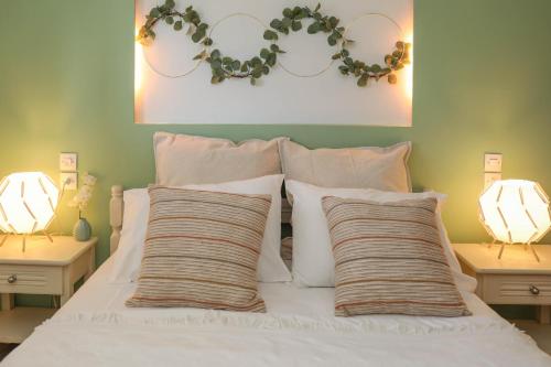 a bed with white pillows and areath above it at Tramontana House2 in Skiathos
