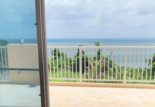 a view of the ocean from a balcony at Kasane / The Family Villa in Ishigaki Island