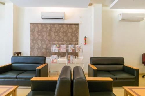 a waiting room with two chairs and a table at Crescent Park in Chennai