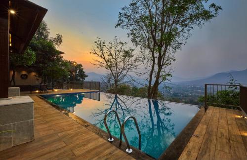 a swimming pool with a view of the mountains at Mrudgandh Pool Villa Girivan Near Pune Mumbai in Mulshi