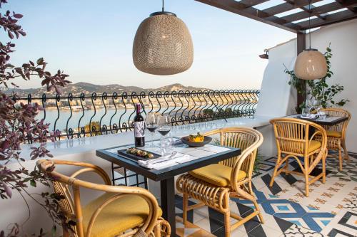 a patio with a table and chairs with a view at Hotel La Torre del Canonigo - Small Luxury Hotels in Ibiza Town