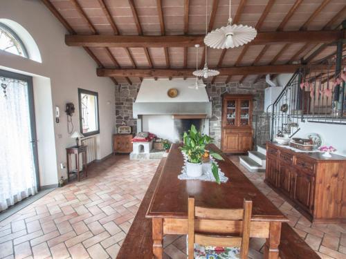 a large kitchen with a large wooden table in a room at Villa Il Circolo by Interhome in Borselli