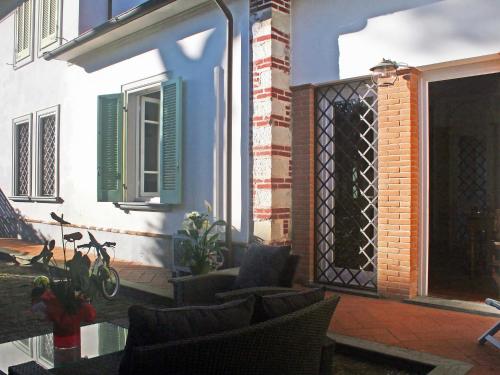 a patio with chairs and a fence on a house at Villa Lorenzo by Interhome in Forte dei Marmi