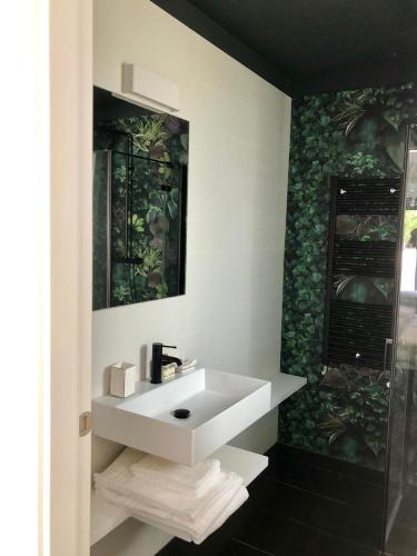 a bathroom with a white sink and a shower at Sunrise Rooms in Grado
