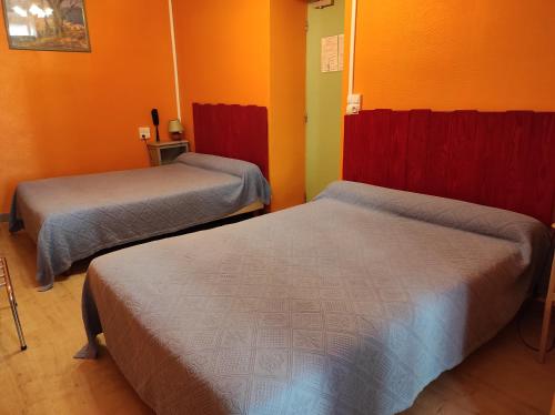 Postel nebo postele na pokoji v ubytování Hotel Régina