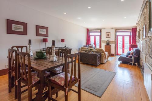 a living room with a wooden table and a couch at Go2oporto - Ribeira do Porto in Porto