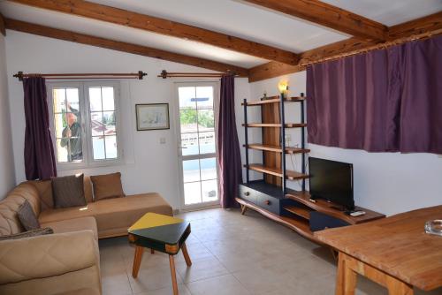 a living room with a couch and a tv at Aquarius Hotel in Side