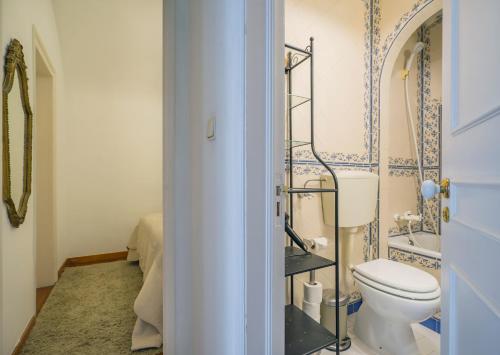 a bathroom with a toilet and a sink at Romantic Apartment + Tejo River View in Lisbon
