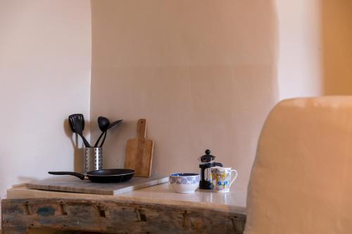 a table with various kitchen utensils on it at Caveland in Karterados