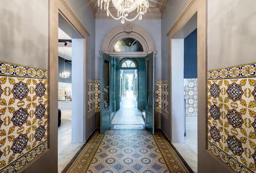 a hallway with a large mirror and a large door at Charm Palace Porto in Porto
