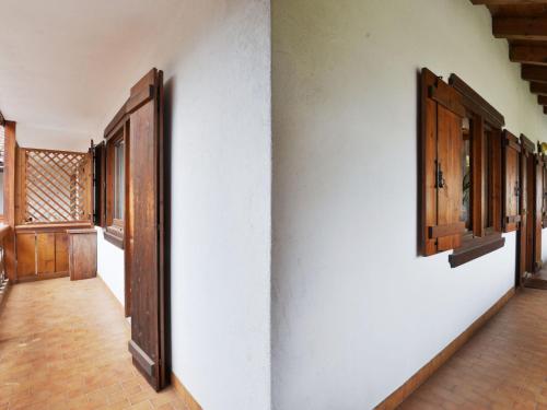 an empty hallway with wooden doors and windows at Apartment Villaggio Ladino by Interhome in Mazzin