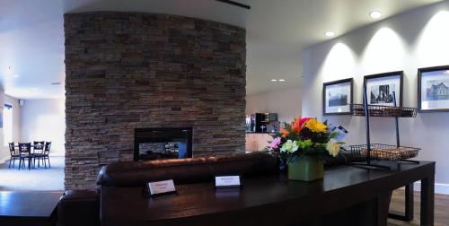 a living room with a couch and a fireplace at Kanata Whitecourt in Whitecourt