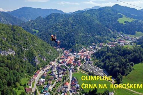 a person on a zip line in the mountains at Gostilna PIK in Prevalje