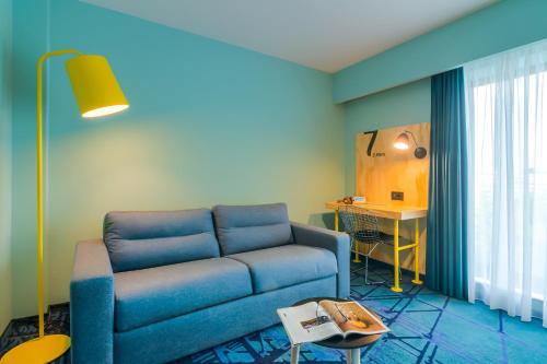 Zona de estar de ibis Styles Bucharest Erbas