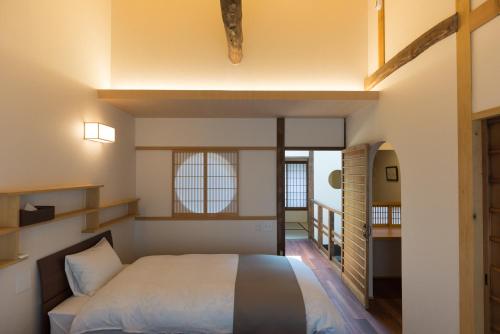 a bedroom with a large bed in a room at Rikyu-an Machiya House in Kyoto