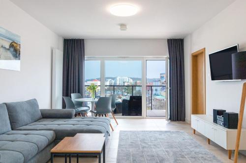 a living room with a couch and a table at Prima Playa in Międzyzdroje