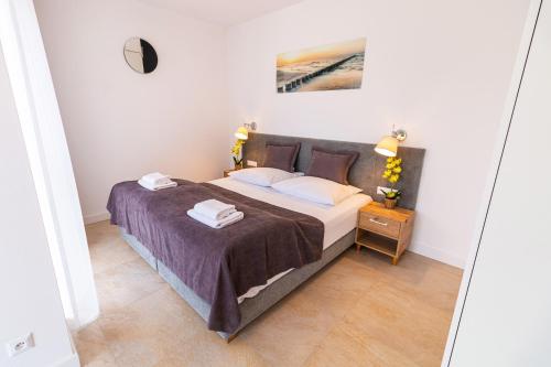 a bedroom with a bed and a mirror at Prima Playa in Międzyzdroje