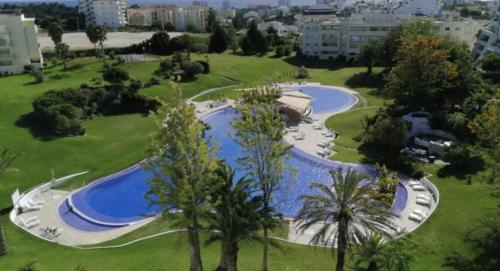 
a large body of water surrounded by trees at Vila Marachique Mariosilvat in Alvor
