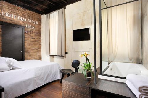 a hotel room with a bed and a bath tub at Relais Orso in Rome