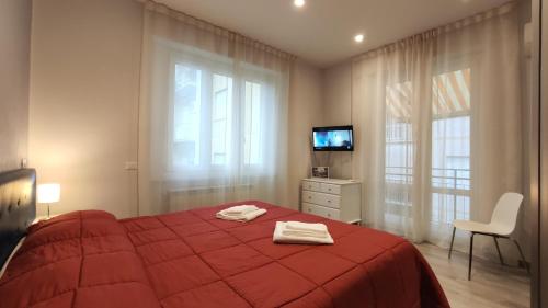 a bedroom with a red bed with two towels on it at Residence Mare Azzurro in Lerici