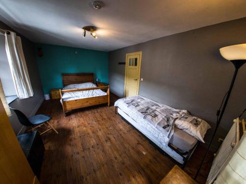a bedroom with two beds and a lamp in it at B&B Aux 10 Clefs in Durbuy