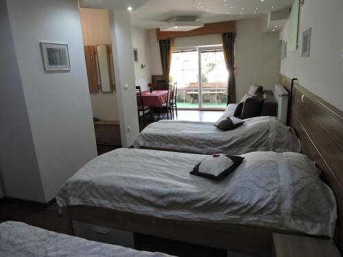 a hotel room with two beds and a living room at Gostilna PIK in Prevalje