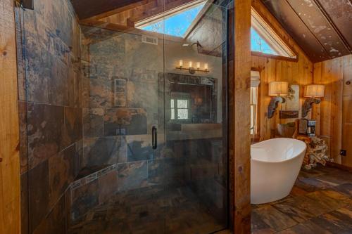 a bathroom with a shower with a tub and a sink at The Nest in Blue Ridge