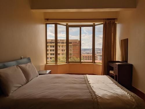 Postel nebo postele na pokoji v ubytování Prestige Hotel Suites