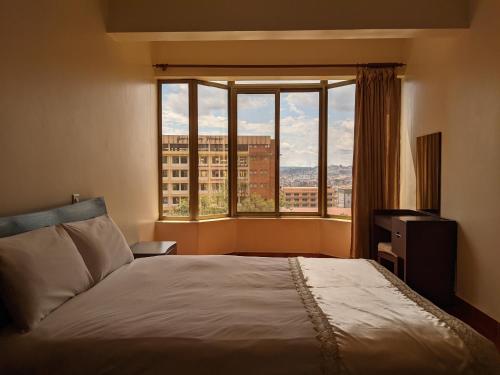 מיטה או מיטות בחדר ב-Prestige Hotel Suites