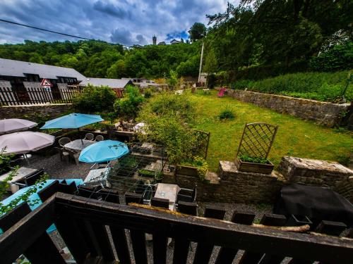 an aerial view of a garden with umbrellas and tables at B&B Aux 10 Clefs in Durbuy
