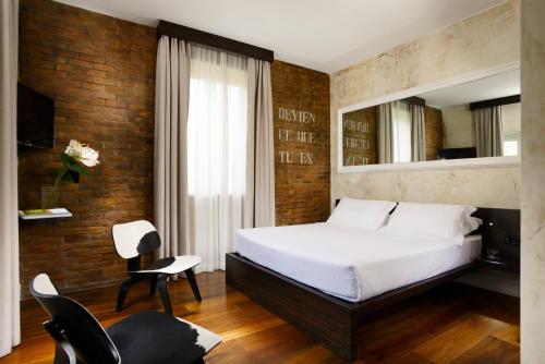 a bedroom with a large bed and a mirror at Relais Orso in Rome