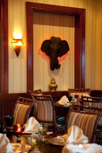 a dining room with an elephant projected on the wall at Regency Tunis Hotel in Gammarth