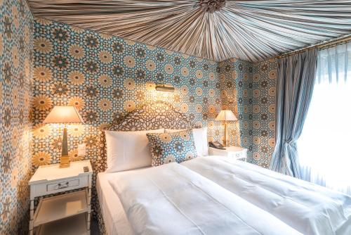 a bedroom with a large bed and a wall at Château Gütsch in Luzern