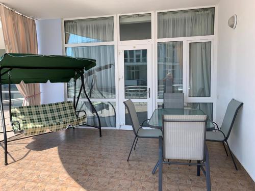 a dining room with a glass table and chairs at Town-house Golden Bugaz in Karolino-Buhaz