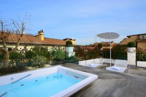 a swimming pool on a patio with a house at Relais Orso in Rome