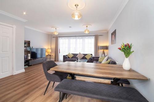 a living room with a wooden table and chairs at Thomas, Off Leeman Road in York