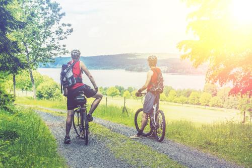 two men riding bikes down a gravel road at Hotel Am Stadtpark in Buxtehude