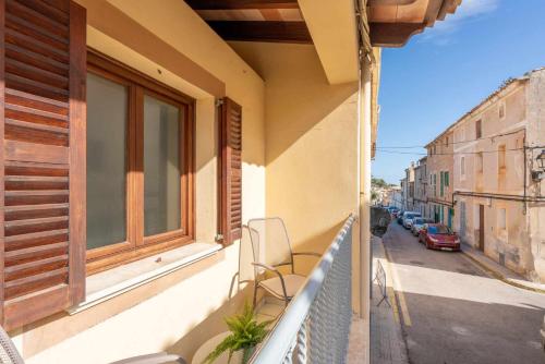 a balcony of a building with a chair on it at Can Cosset Holiday Home in Capdepera