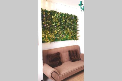 a couch in a living room with a green hedge at La musa del Poeta in Quesada