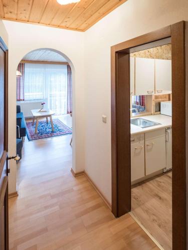 an open door to a kitchen with a table at Haus Ferienglück in Ramsau am Dachstein