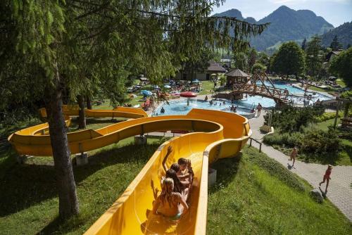 a group of people riding a slide at a water park at BIO- Bauernhof Obermaurach in Walchsee