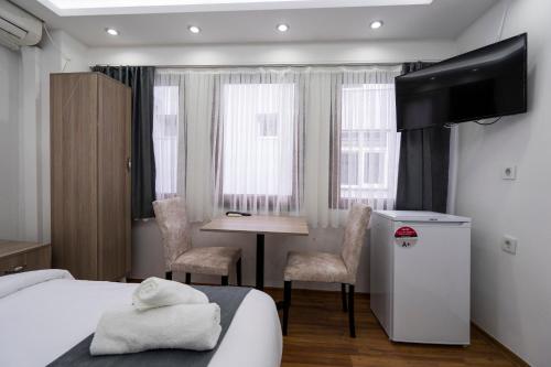 a hotel room with a bed and a table and chairs at Galataport suites in Istanbul