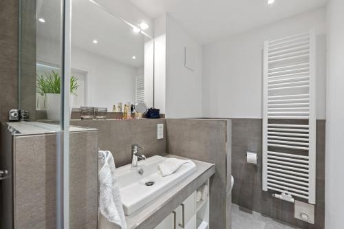 a bathroom with a white sink and a shower at Schulstr_ 15 _Sinja_ in Zingst