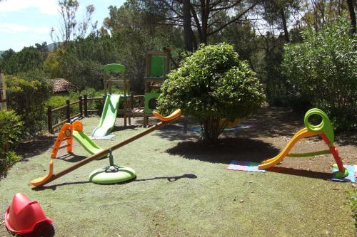 a group of childrens playground equipment in a yard at Hotel Capo Sud in Lacona