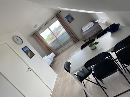 an office with a table and chairs and a clock at Oasen Samsø in Nordby